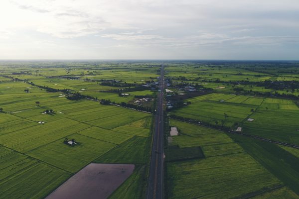 Aerial view over small village, Country roadside.